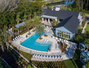 An L-shaped pool surrounded by apartment buildings and trees.