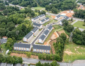 An aerial shot of a residential projects surrounded by trees