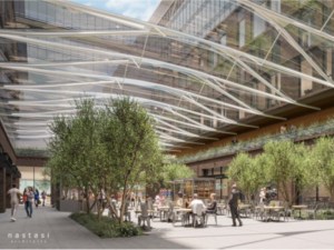 A glass-ceilinged indoor space with trees