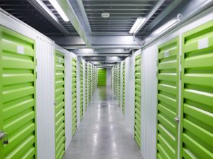 Image of empty corridor of storage room with green storage boxes