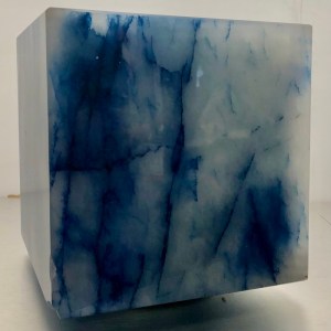 The flat surface of a blue stone cube