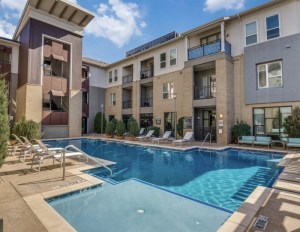 A three-story apartment property with a pool