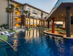 An outdoor pool with apartments in the background