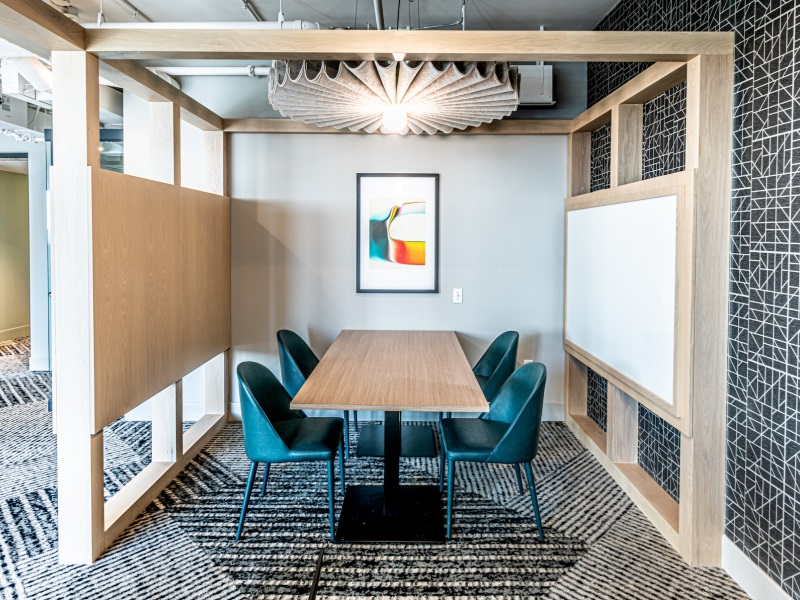A semi-private “pocket” space at a multifamily property with seating and a table