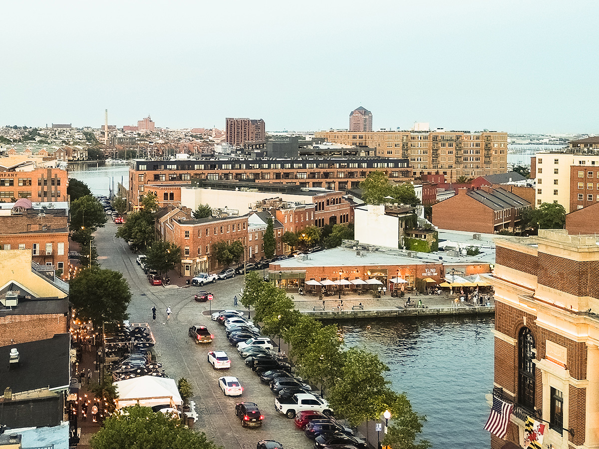 View of drone angles of the Baltimore Inner Harbor of a scenic waterfront view during sunset.