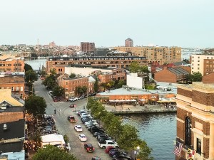 View of drone angles of the Baltimore Inner Harbor of a scenic waterfront view during sunset.