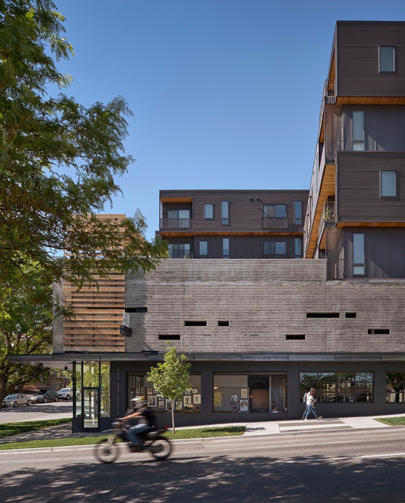 MOTO is a 64-unit, mixed-use boutique apartment community in Denver. The property has a particular focus on compact housing and shared amenities. The lobby is designed to foster a sense of community, offering seating and communal tables. The property includes a coffee house and barber shop. Image by Ryan Gobuty, courtesy of Gensler