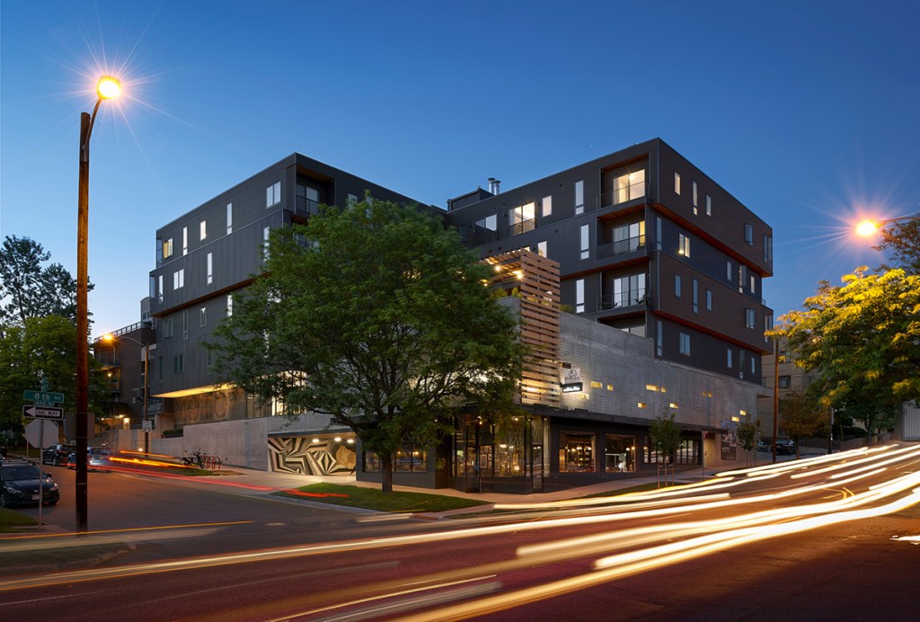 MOTO is a 64-unit, mixed-use boutique apartment community in Denver. The property has a particular focus on compact housing and shared amenities. The lobby is designed to foster a sense of community, offering seating and communal tables. The property includes a coffee house and barber shop. Image by Ryan Gobuty, courtesy of Gensler