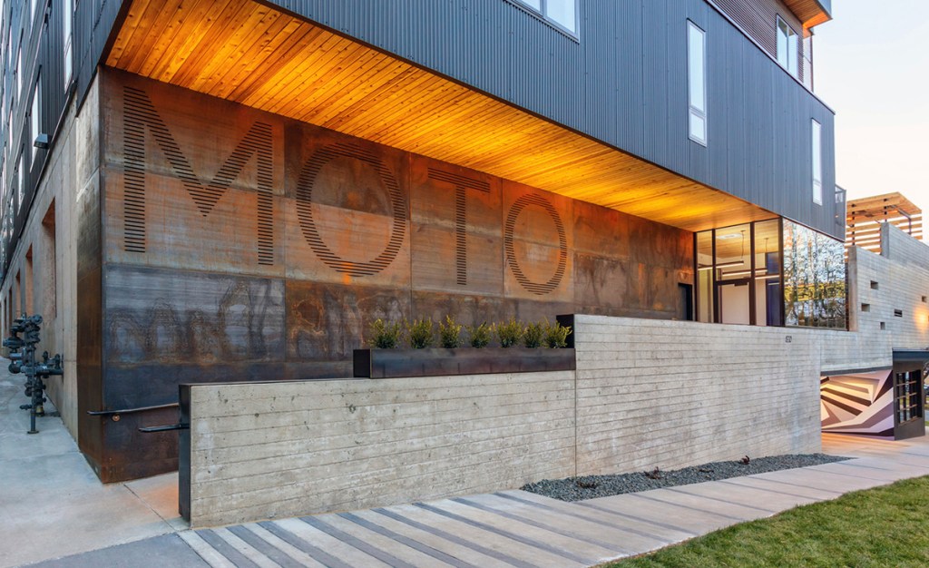 MOTO is a 64-unit, mixed-use boutique apartment community in Denver. The property has a particular focus on compact housing and shared amenities. The lobby is designed to foster a sense of community, offering seating and communal tables. The property includes a coffee house and barber shop. Image by Ryan Gobuty, courtesy of Gensler