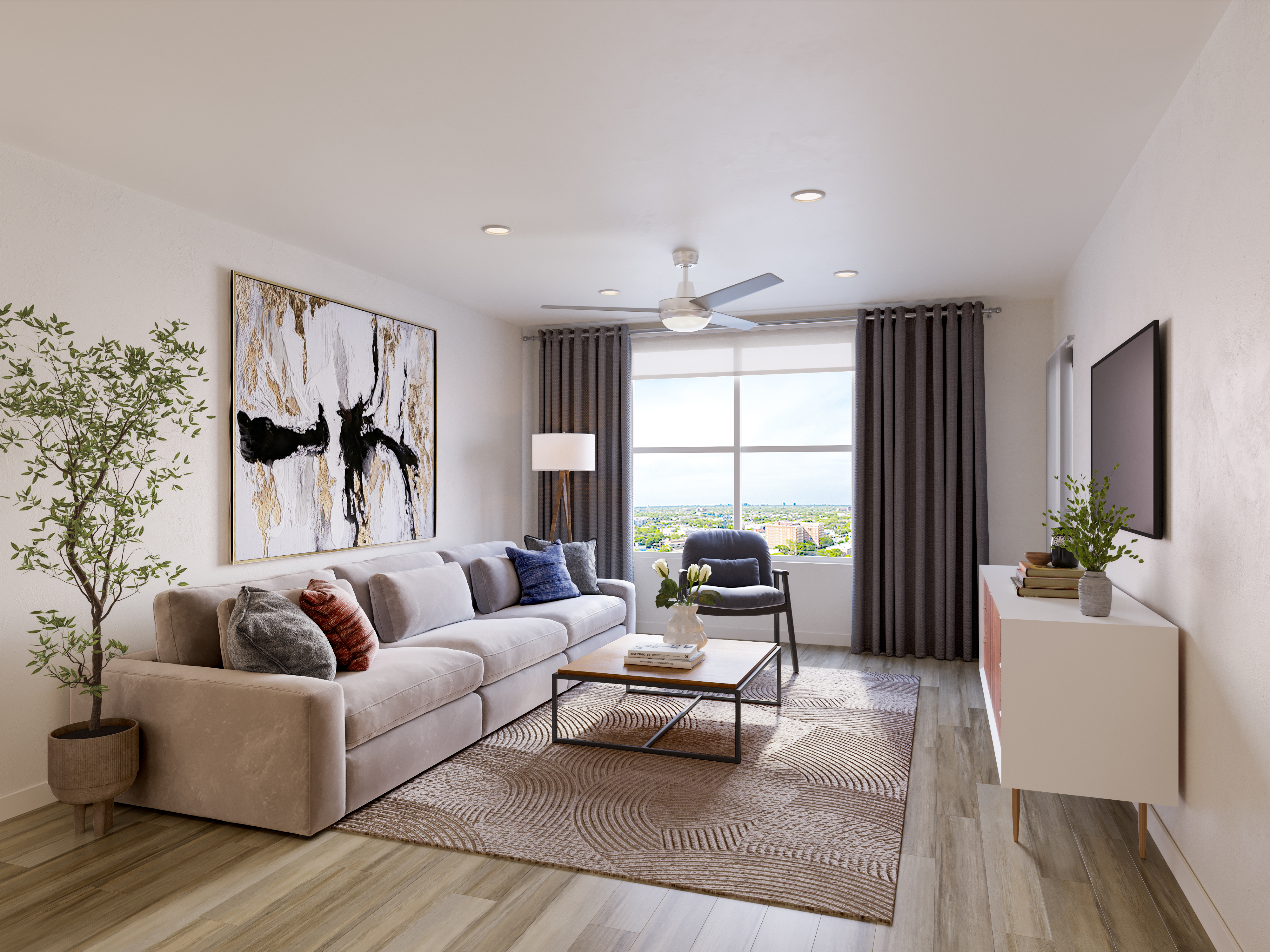Shot of one of the living rooms of Zia Apartments, featuring a long couch, a coffee table and a TV.