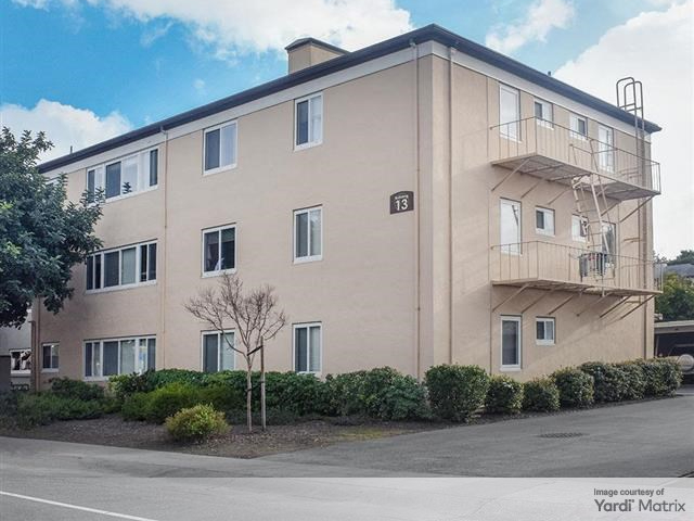 Exterior shot of one of the 52 buildings making up Hillsdale Garden Apartments, a multifamily community in San Mateo, Calif.