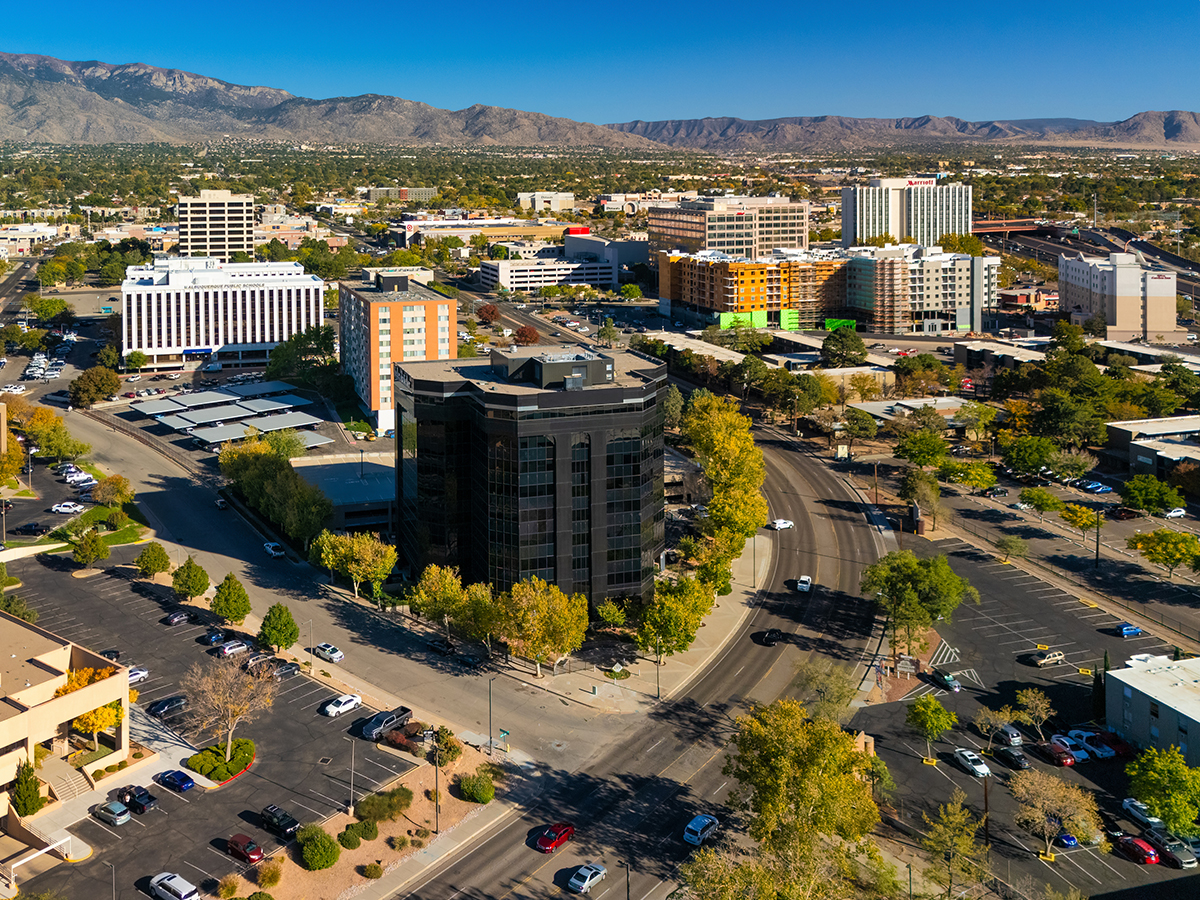 Aerial of Uptown Albuquerque in Albuquerque, NM, with the Sandia Mountains in the background.