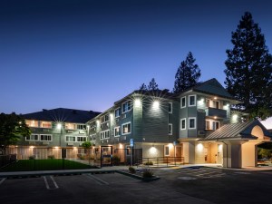 Night shot of The Heartwood Apartments, a hotel-to-affordable housing conversion in Mountain View, Calif.