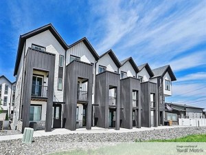Exterior shot of Citadel at Castle Pines in Castle Pines, Colo, a villa-style community with white and gray exterior