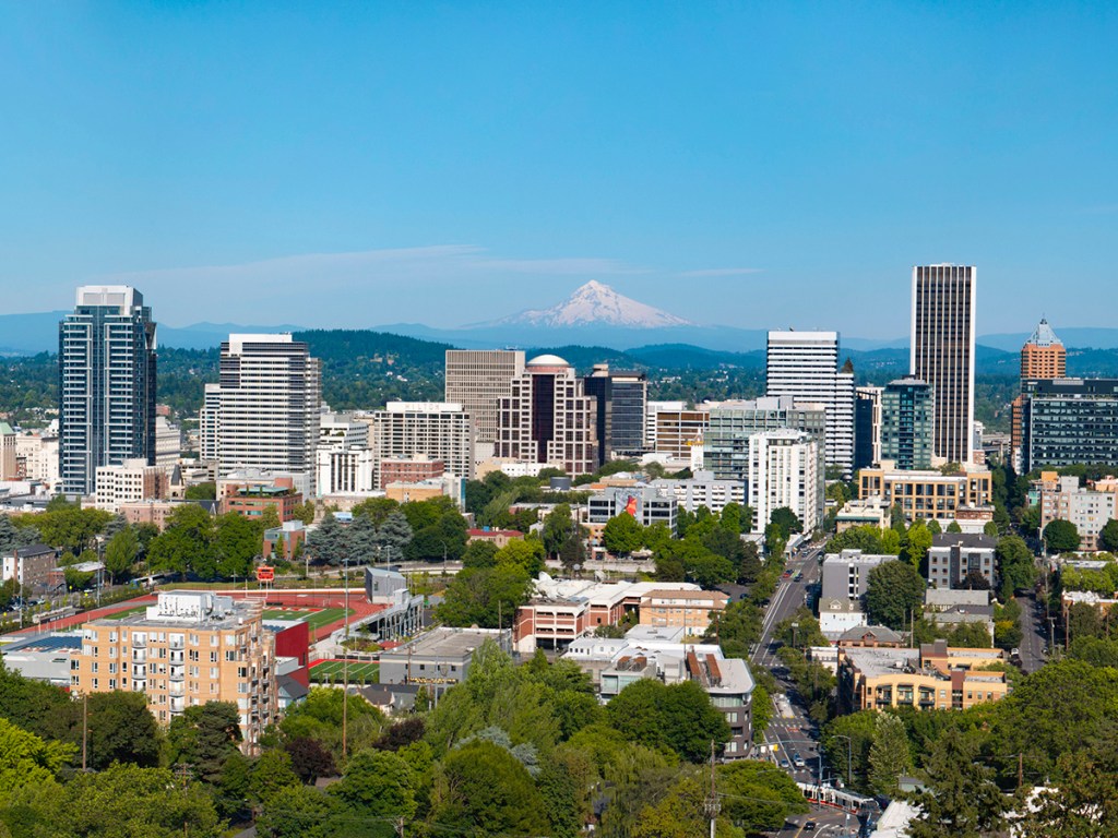 An aerial panorama of downtown Portland, Oregon with Mt Hood in the background.