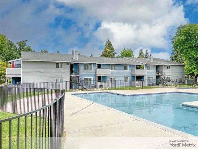 Exterior shot featuring one of Logan Park's buildings, as well as one of its swimming pools.