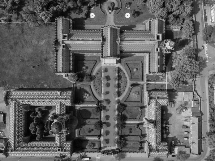 Black-and-white aerial shot overlooking a community.