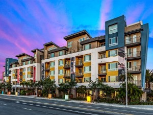 Exterior shot of Bell South Bay, a five- and six-story building with white, yellow, blue and beige exterior.
