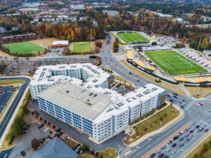 Aerial view of Bixby Kennesaw, a four- and five-story white building, surrounded by stadiums.