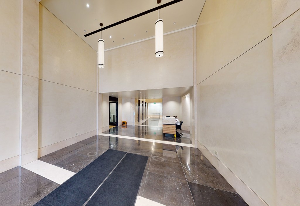 The office building soon to become multifamily is being stripped to its core and shell. “Before” image of South Temple Tower lobby courtesy of Hines