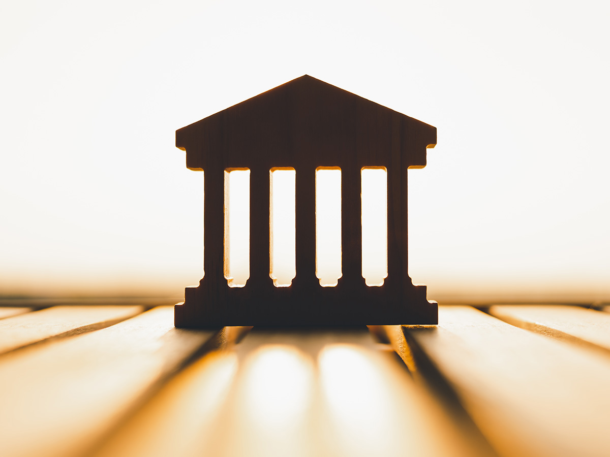 Silhouette of Bank symbol on wood table. Concepts of the banking system, rising interest rates, inflation, deflation, and savings.