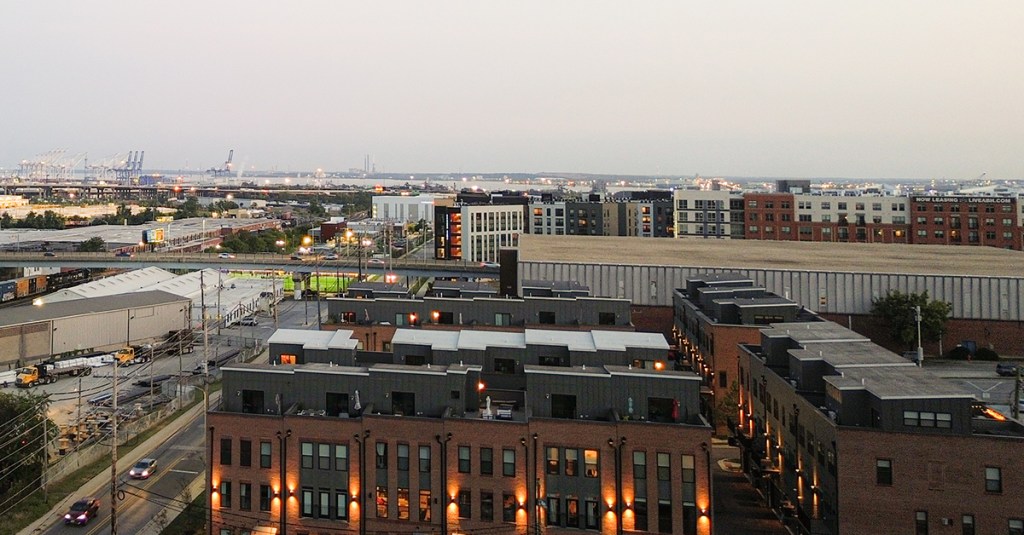 Aerial drone view of Baltimore city while a cargo train is transporting goods