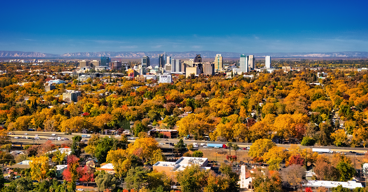Aerial skyline view of Sacramento, with Downtown Sacramento in the center, and Midtown Sacramento with beautiful autumn colors and the Business I-80 in the foreground, and the Vaca Mountain Range in the background.