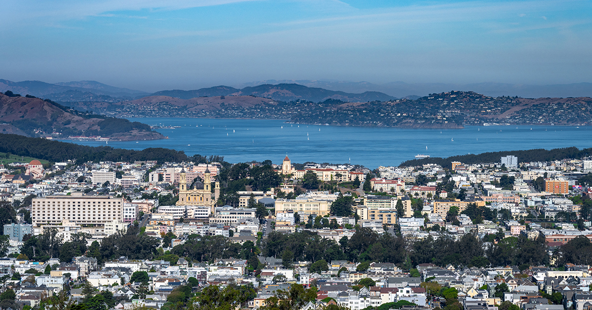 Aerial view of San Francisco, California, with a panoramic cityscape overlooking the Bay Area. This stunning scene captures the vibrant urban landscape, historic architecture, and deep blue waters of the Pacific coast.