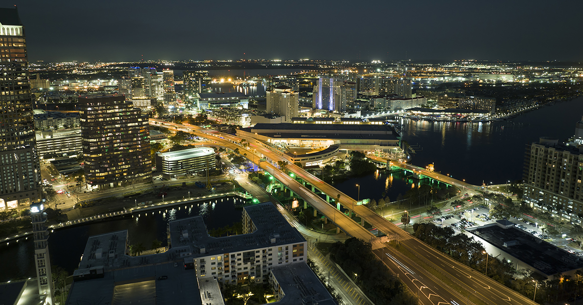 Aerial view of american highway junction at night with fast driving vehicles in Tampa, Florida. View from above of USA transportation infrastructure.