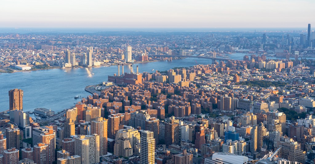 New York, NY, USA - August 20, 2022: Aerial view of New York city skyline and Hudson River viewed from the top of the building at sunset in New York, NY, USA.
