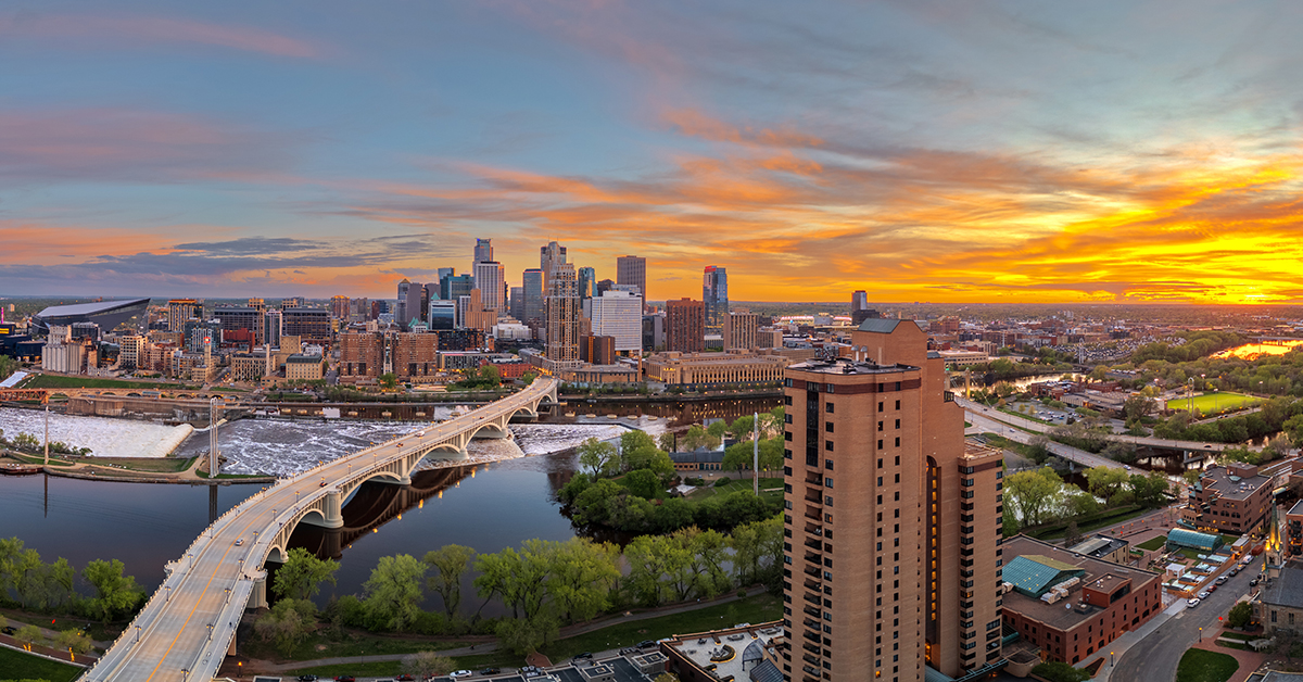 Minneapolis, Minnesota, USA downtown city skyline over the river at dusk.