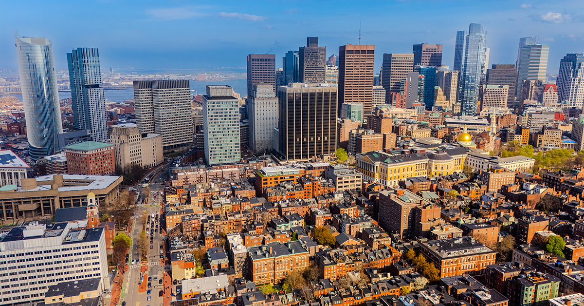 Sunny cityscape of modern Boston, Massachusetts, USA. Footage above old-fashioned orange brick buildings with the view on high-rise downtown.