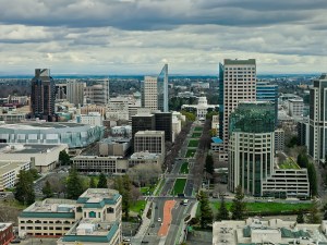 Drone shot of downtown office buildings and the California State Capitol in Sacramento on a cloudy day.