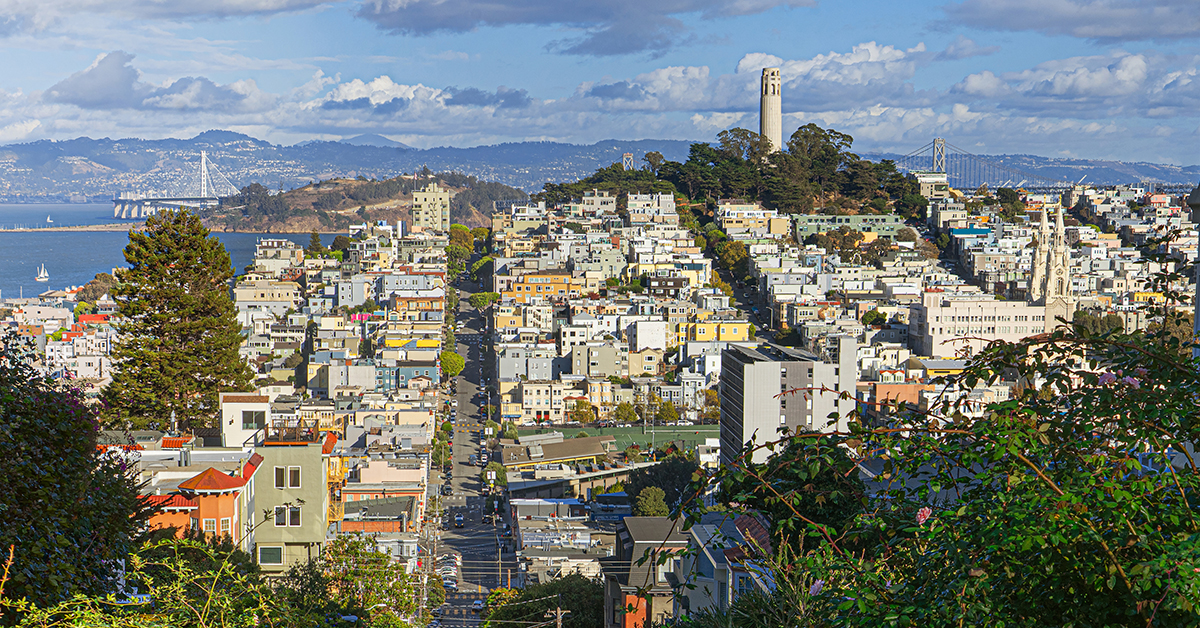 Telegraph Hill, Lombard Street, Yerba Buena Island, The Bay Bridge, Treasure Island, Coit Tower, and the San Francisco Bay visible from this high viewpoint in San Francisco, California