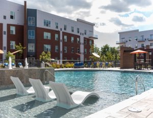 Exterior image of Ellipse Urban Apartments, with its swimming pool in the foreground.