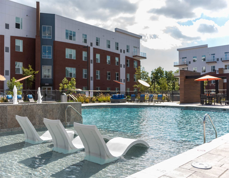 Exterior image of Ellipse Urban Apartments, with its swimming pool in the foreground.