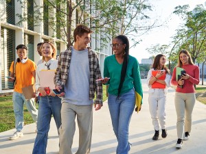 Group of multiethnic students walking going to classroom at university. Concept of First day of school.