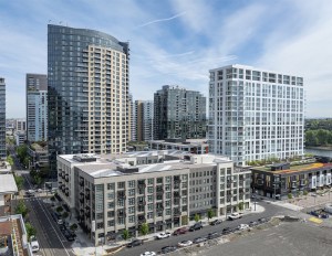 A photo of Willamette Tower, a 23-story multifamily community, and The Olivia, a portfolio-style multifamily building.