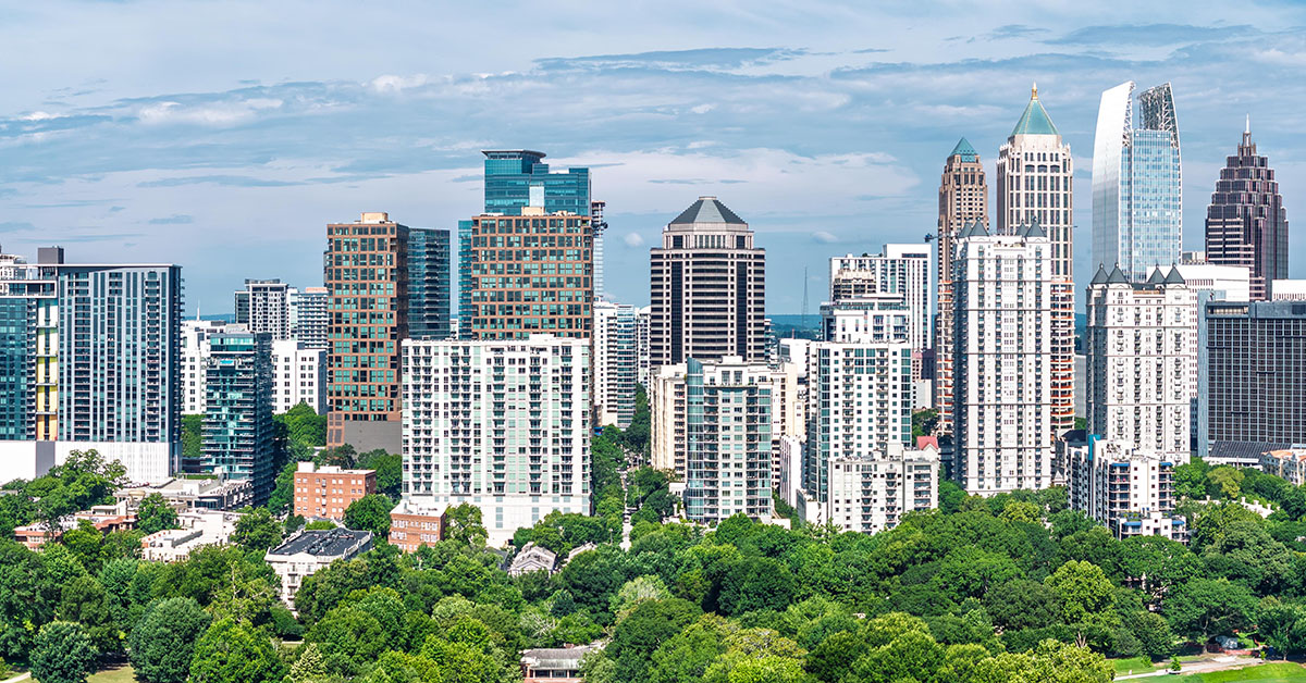 Drone angle view of Atlanta Georgia skyline with Piedmont Park and lake in the foreground.