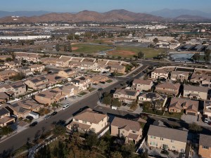 Jurupa Valley, California, USA - November 9, 2024: Afternoon sun shines on newly constructed school and suburban homes.