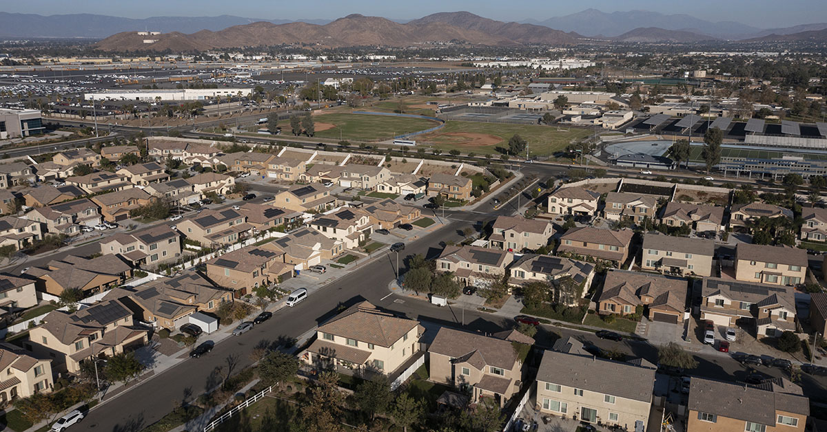 Jurupa Valley, California, USA - November 9, 2024: Afternoon sun shines on newly constructed school and suburban homes.
