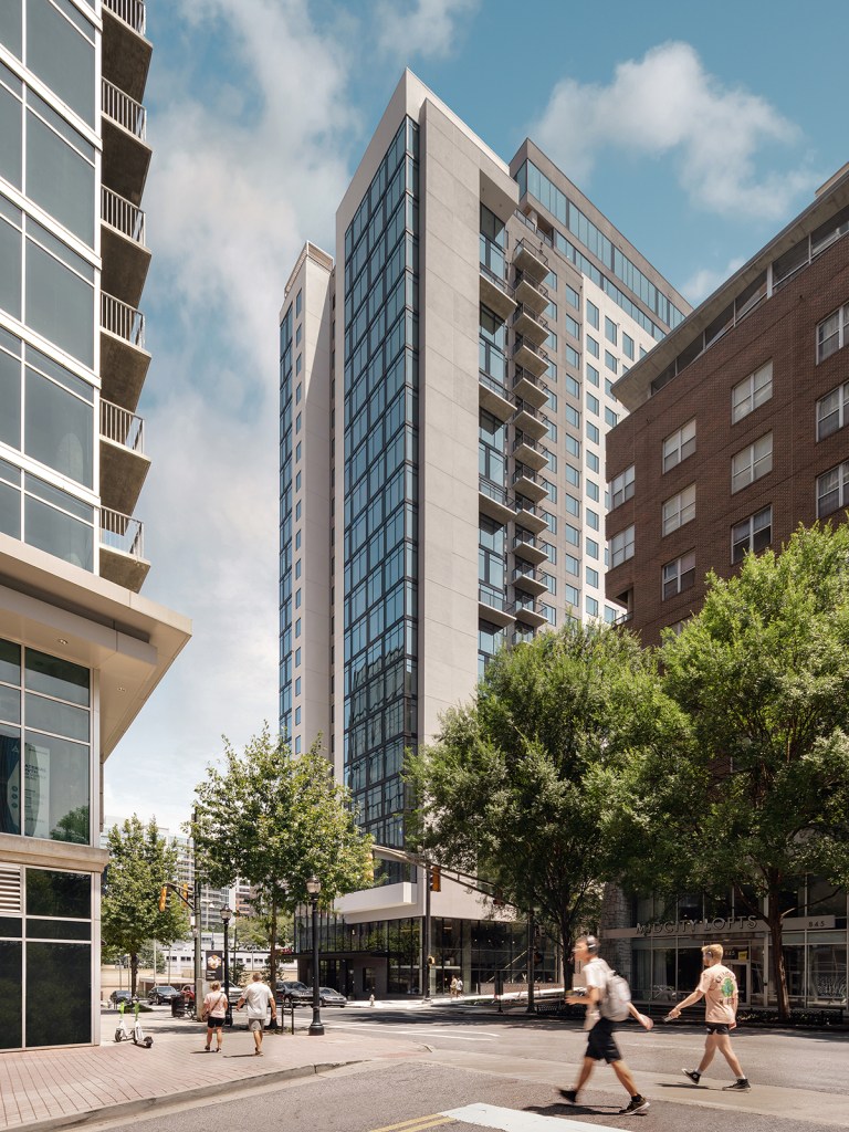 The high-rise sits in a central Atlanta location, with the lobby and patio available to residents and community members alike.