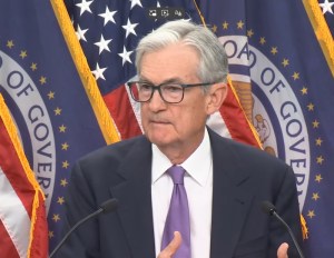 A photo showing Federal Reserve Chair Jerome Powell speaking at a press conference.