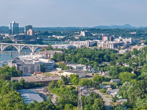 Drone angle view of Knoxville skyline, bridges, and Tennessee River.