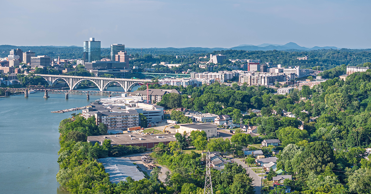 Drone angle view of Knoxville skyline, bridges, and Tennessee River.