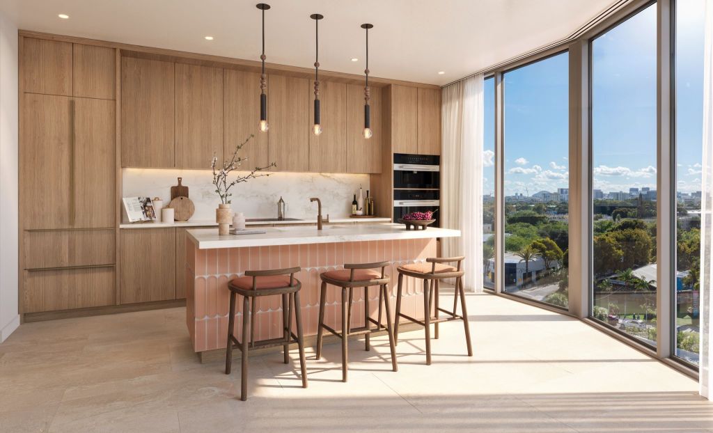 The kitchen bathed in warm hues at he Cloud One Hotel & Residences