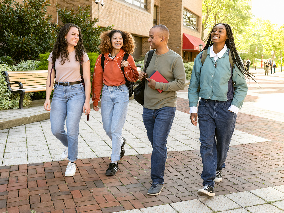Group of students going to classroom at university. Concept of First day of school.