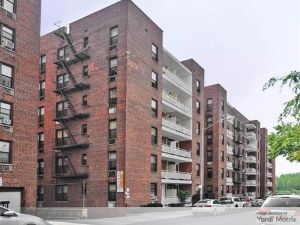 Six-story brown brick New York City apartment building from mid-20th Century