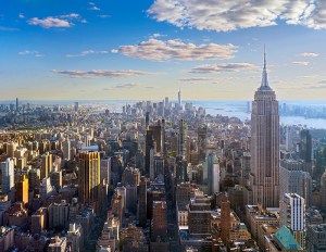 An aerial photo of New York City, featuring the Empire State Building at the forefront.