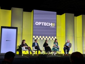 A photo of a panel at OPTECH 2025 featuring leaders of RETTC.